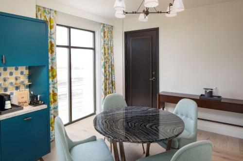 a dining room with a table and chairs at Canopy By Hilton Charlotte SouthPark in Charlotte