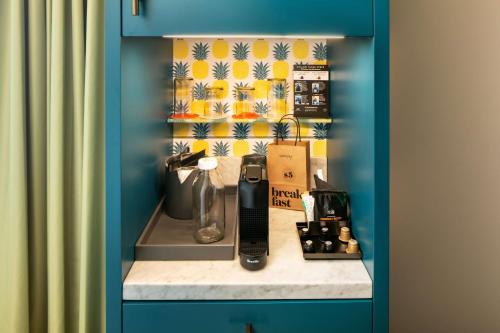 a kitchen counter with a appliance on top of it at Canopy By Hilton Charlotte SouthPark in Charlotte
