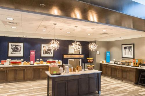 a restaurant with a counter with food on it at Hampton Inn & Suites Charlotte/Ballantyne, Nc in Charlotte