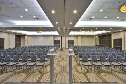 an empty room with rows of chairs in a hall at Embassy Suites Charlotte in Charlotte