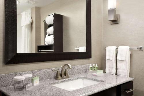a bathroom with a sink and a mirror and towels at Homewood Suites by Hilton Columbus OSU, OH in Columbus