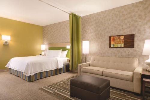 a hotel room with a bed and a couch at Home2 Suites By Hilton Columbus Dublin in Dublin