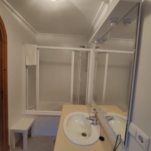 a white bathroom with a sink and a shower at EL COBIJO in Mojados