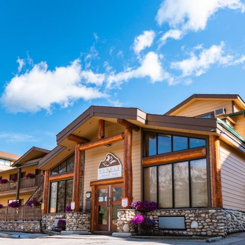 a lodge with a sign on the front of the building at Rundle Mountain Lodge in Canmore