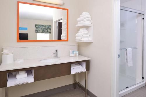 a bathroom with a sink and a mirror at Hampton Inn and Suites Port Aransas in Port Aransas