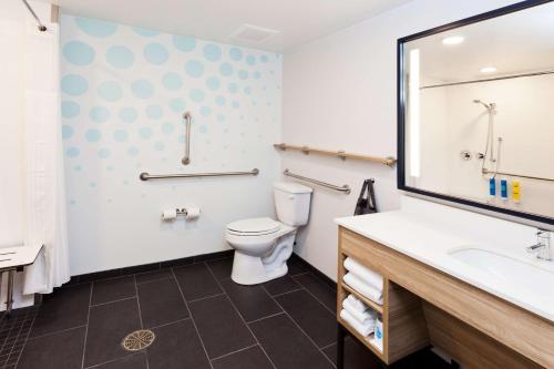 a bathroom with a toilet and a sink at Tru by Hilton Auburn in Auburn