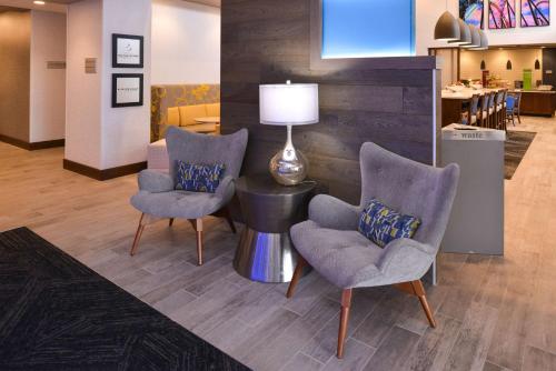 a lobby with two chairs and a table with a lamp at Hampton Inn & Suites Cincinnati-Mason, Ohio in Mason