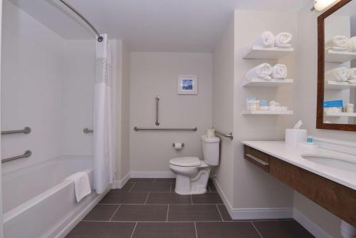 a bathroom with a toilet and a tub and a sink at Hampton Inn & Suites Cincinnati-Mason, Ohio in Mason