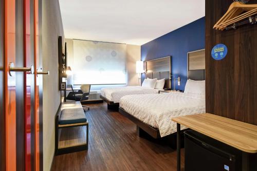 a hotel room with two beds and a desk at Tru By Hilton Cincinnati Airport South Florence in Florence