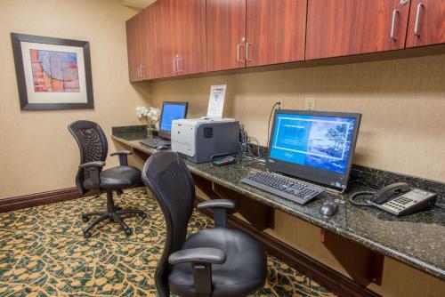 an office cubicle with three computers on a desk at Hampton Inn & Suites Cincinnati-Union Centre in West Chester