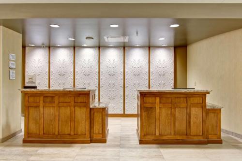 a lobby with two wooden cabinets and a wall of glass at Homewood Suites by Hilton Cincinnati-Downtown in Cincinnati