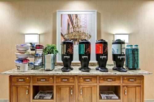 a counter with a bunch of bottles on it at Homewood Suites by Hilton Cincinnati-Downtown in Cincinnati