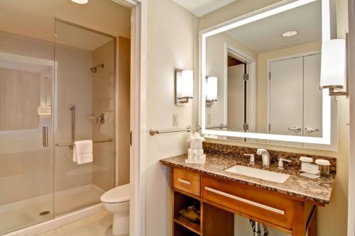 a bathroom with a sink and a shower and a mirror at Homewood Suites by Hilton Cincinnati-Downtown in Cincinnati
