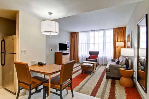 a living room with a dining table and a living room at Homewood Suites by Hilton Cincinnati-Downtown in Cincinnati