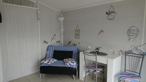 a room with a table and two chairs and a table at La campagne a la mer in Piédemont