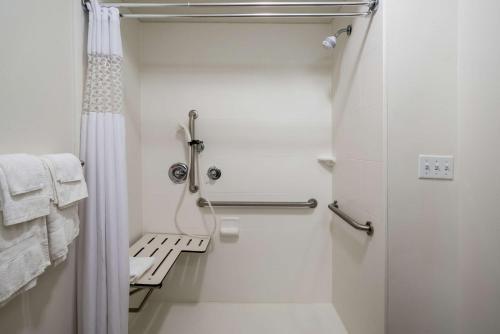 a white bathroom with a shower and a toilet at Hampton Inn Corydon in Corydon