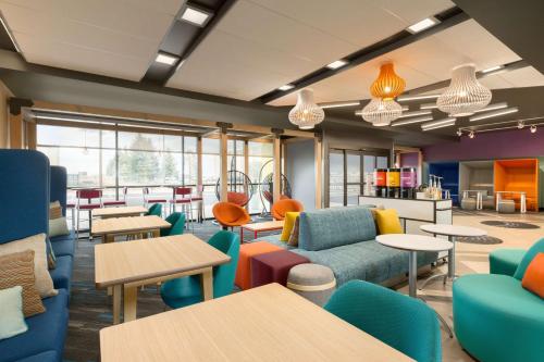 a waiting room with colorful furniture and tables at Tru By Hilton Cheyenne in Cheyenne