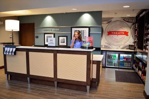 a woman standing behind a counter in a store at Hampton Inn & Suites - DeLand in De Land