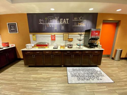 a lobby with a counter with a sign on the floor at Hampton Inn & Suites - DeLand in DeLand