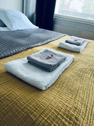 two towels are sitting on top of a bed at Compact apartment in Rauma in Rauma