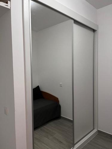 a sliding glass door with a bed in a room at Casa Mar e Sol - Murdeira - Ilha do Sal in Palha Verde