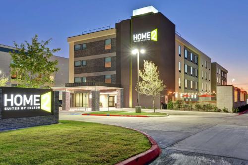 un bâtiment d'hôtel avec une enseigne devant dans l'établissement Home2 Suites By Hilton McKinney, à McKinney