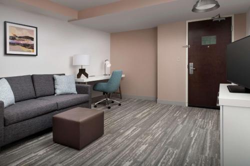 a living room with a couch and a desk at Hilton Garden Inn Dallas/Duncanville in Duncanville