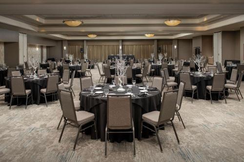 a ballroom with tables and chairs and a room filled with at Hilton Garden Inn Dallas/Duncanville in Duncanville