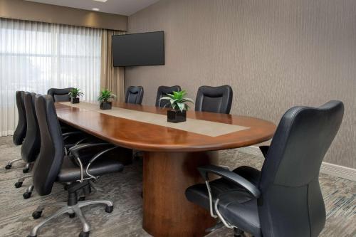 a conference room with a wooden table and chairs at Hilton Garden Inn Dallas/Duncanville in Duncanville