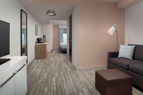 a living room with a couch and a table at Hilton Garden Inn Dallas/Duncanville in Duncanville