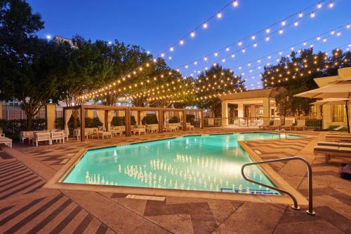 a swimming pool with lights and a building at DoubleTree by Hilton Dallas Market Center in Dallas