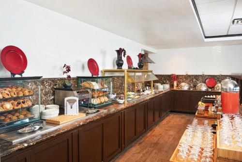 a buffet line in a restaurant with a lot of food at DoubleTree by Hilton Dallas Market Center in Dallas