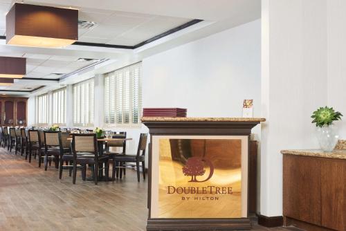 a dining room with a table and chairs at DoubleTree by Hilton Dallas Market Center in Dallas