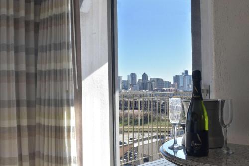 a room with a window with wine bottles and glasses at DoubleTree by Hilton Dallas Market Center in Dallas