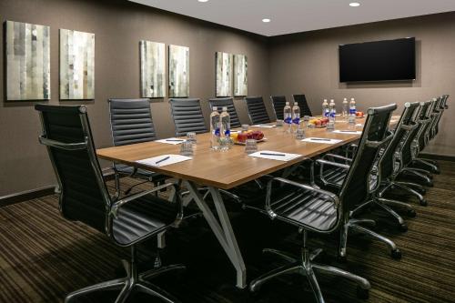 a conference room with a long wooden table and chairs at DoubleTree by Hilton Dallas Market Center in Dallas