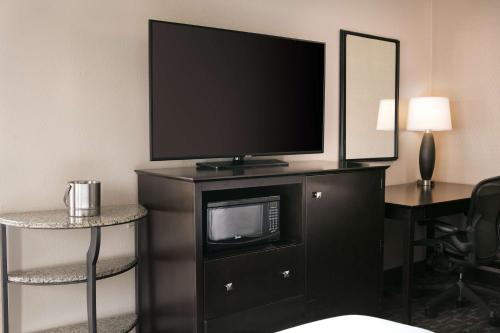 a flat screen tv sitting on a dresser in a hotel room at DoubleTree by Hilton Dallas Market Center in Dallas