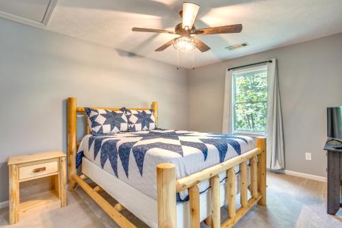 a bedroom with a bed and a ceiling fan at Dreamy Dahlonega Cabin with Deck and Fireplace! in Dahlonega