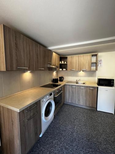 a kitchen with a washer and dryer in it at Katarína in Kežmarok