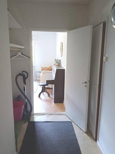 a room with a desk and a door leading to a room at Rauhallinen kaksio, puusauna käytettävissä in Varkaus