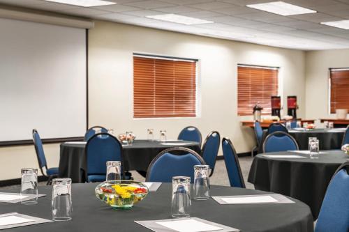 a conference room with tables and blue chairs at Radisson Hotel Portland Airport in Portland