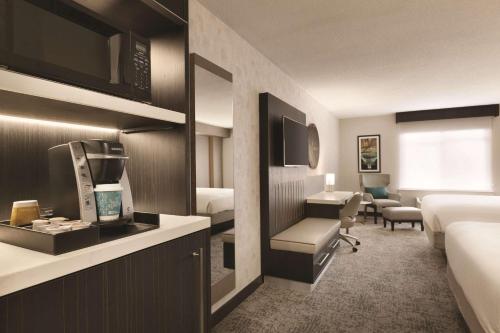 a hotel room with a bed and a kitchen and a living room at Hilton Garden Inn Washington DC Downtown in Washington