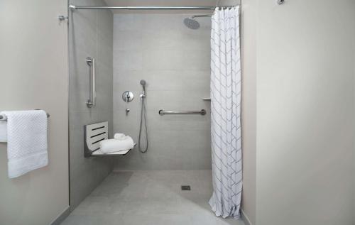 a bathroom with a shower with a shower curtain at Canopy by Hilton Washington DC Embassy Row in Washington