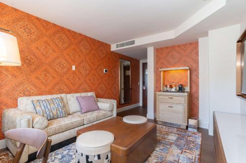 a living room with a couch and a table at Canopy by Hilton Washington DC Embassy Row in Washington