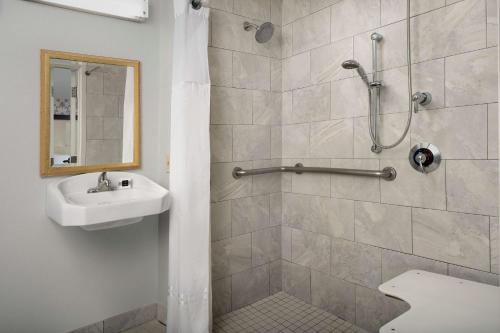 a bathroom with a shower and a sink at West End Washington DC, Tapestry Collection by Hilton in Washington, D.C.