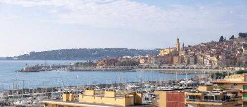 a view of a harbor with boats in the water at Mansfield vue carte Postale Terrasse Piscine 2 in Menton