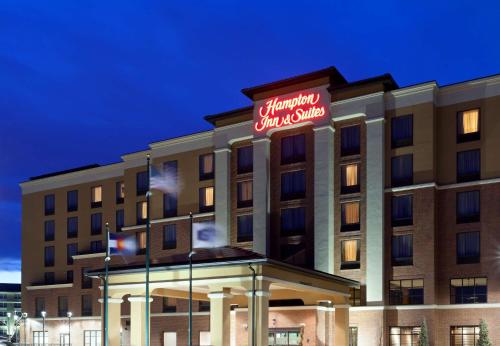 a hotel building with a sign on top of it at Hampton Inn & Suites Denver Airport / Gateway Park in Aurora