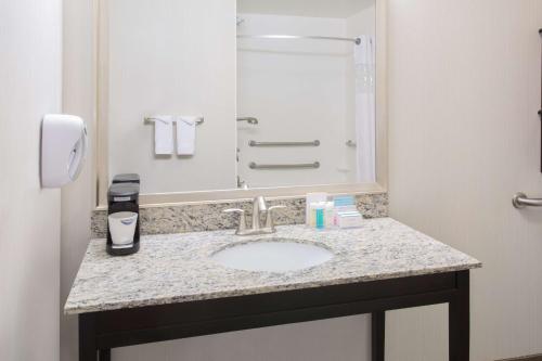 a bathroom with a sink and a mirror at Hampton Inn & Suites Denver Airport / Gateway Park in Aurora