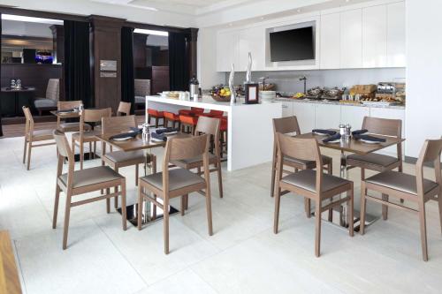 ein Esszimmer mit Tisch und Stühlen und eine Küche in der Unterkunft Hilton Garden Inn Denver/Thornton in Thornton
