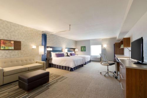 a hotel room with a bed and a television at Home2 Suites by Hilton Denver Highlands Ranch in Highlands Ranch
