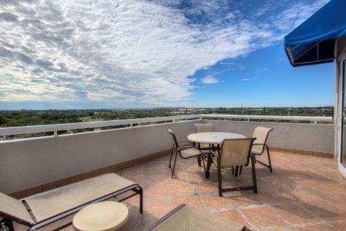 a balcony with a table and chairs and a view at DoubleTree by Hilton Hotel Deerfield Beach Boca Raton in Deerfield Beach